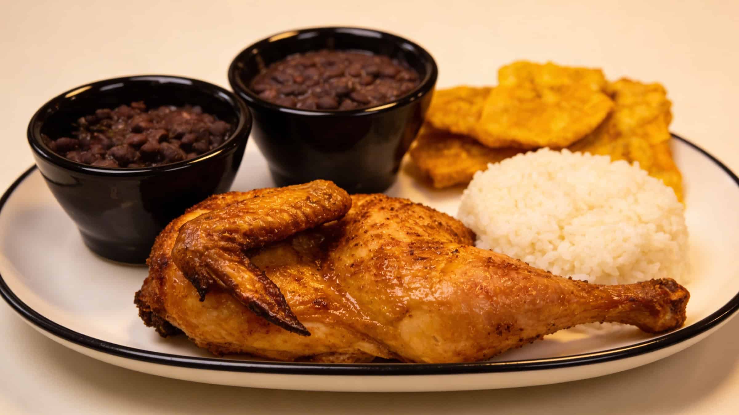 Roast chicken with rice, black beans and tostones